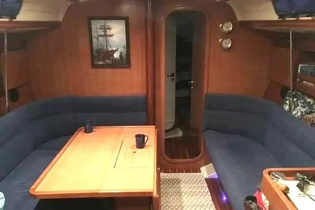 Slide: The Image of Interior of 2004 Dufour 40 Performance yacht with cozy seating and wooden table. - 4