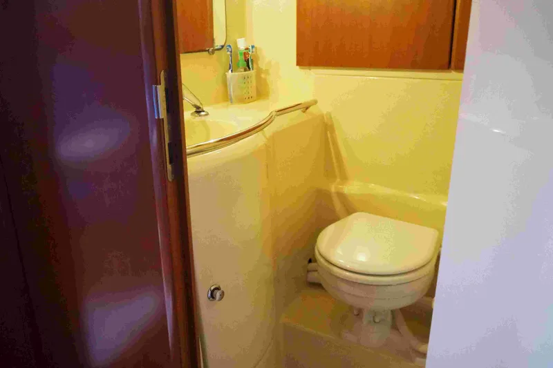 Slide: The Image of Compact bathroom in 2004 Dufour 40 Performance yacht, featuring toilet and sink. - 41