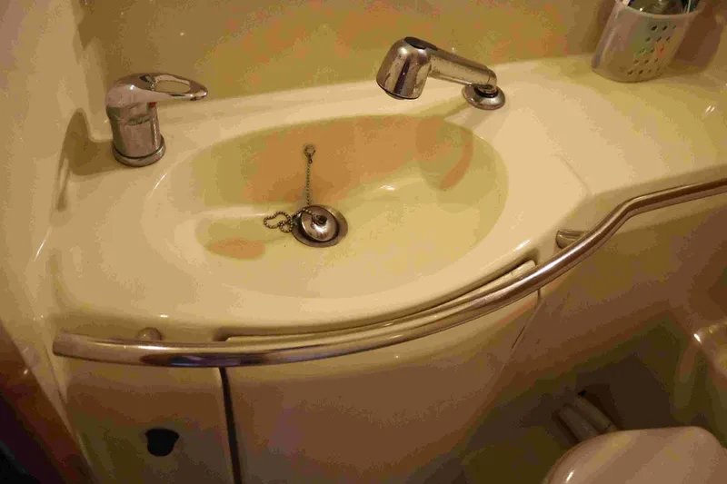 Slide: The Image of Bathroom sink on a 2004 Dufour 40 Performance yacht, featuring chrome fixtures. - 42