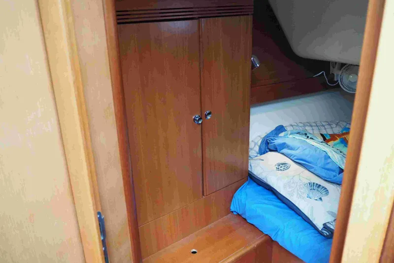 Slide: The Image of Cozy cabin interior of 2004 Dufour 40 Performance yacht with wooden cabinetry and bedding. - 43
