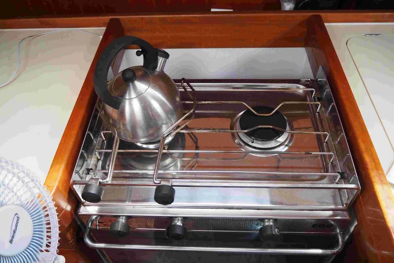 Slide: The Image of Stainless steel kettle on a stove in a 2004 Dufour 40 Performance yacht kitchen. - 44