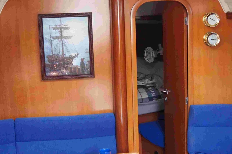 Slide: The Image of Interior of 2004 Dufour 40 Performance yacht with nautical decor and blue seating. - 49