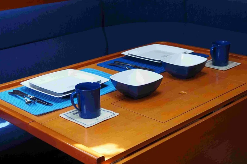 Slide: The Image of Dining setup on a 2004 Dufour 40 Performance yacht with blue tableware. - 51