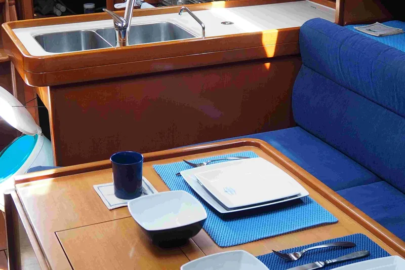 Slide: The Image of Interior of 2004 Dufour 40 Performance yacht with dining setup and sink. - 52