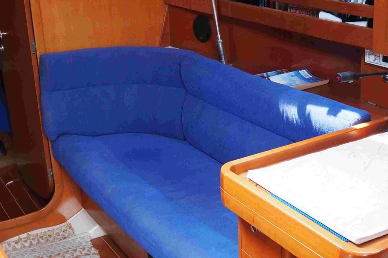 Slide: The Image of Interior of 2004 Dufour 40 Performance yacht with blue seating and wooden accents. - 64