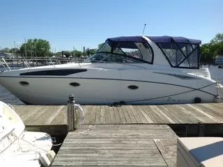 The Image of 2006 Bayliner 325 boat docked on a sunny day. - 0