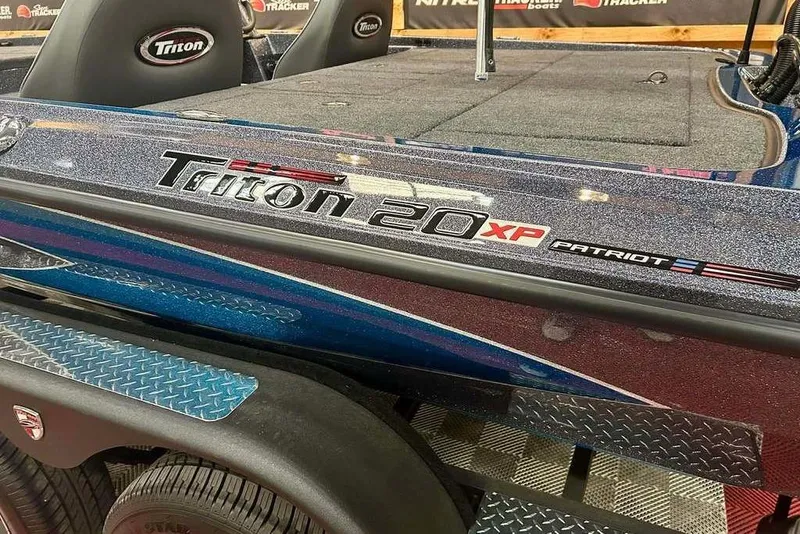 Slide: The Image of 2026 Triton 20XP Patriot boat with sleek design and metallic finish. - 14