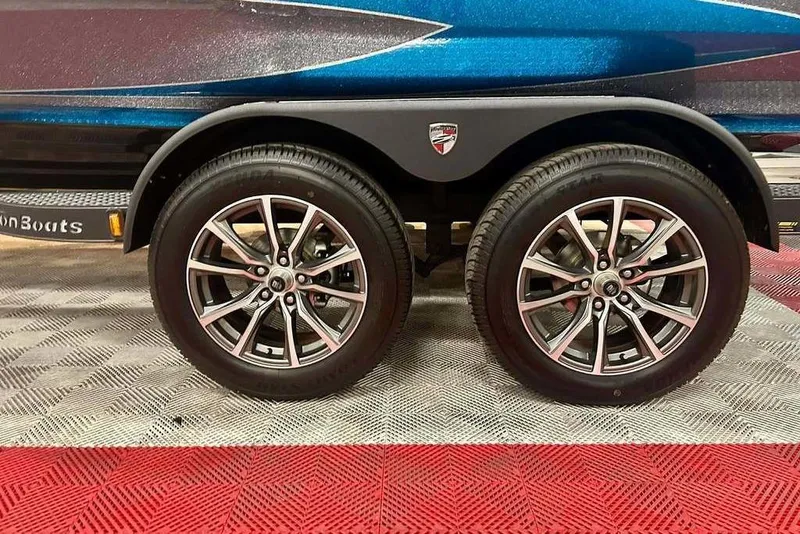 Slide: The Image of 2026 Triton 20XP Patriot trailer with dual wheels on a patterned floor. - 15