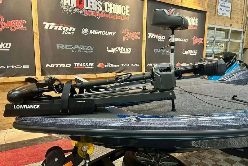 Slide: The Image of 2026 Triton 20XP Patriot boat with Lowrance Ghost trolling motor in showroom. - 8