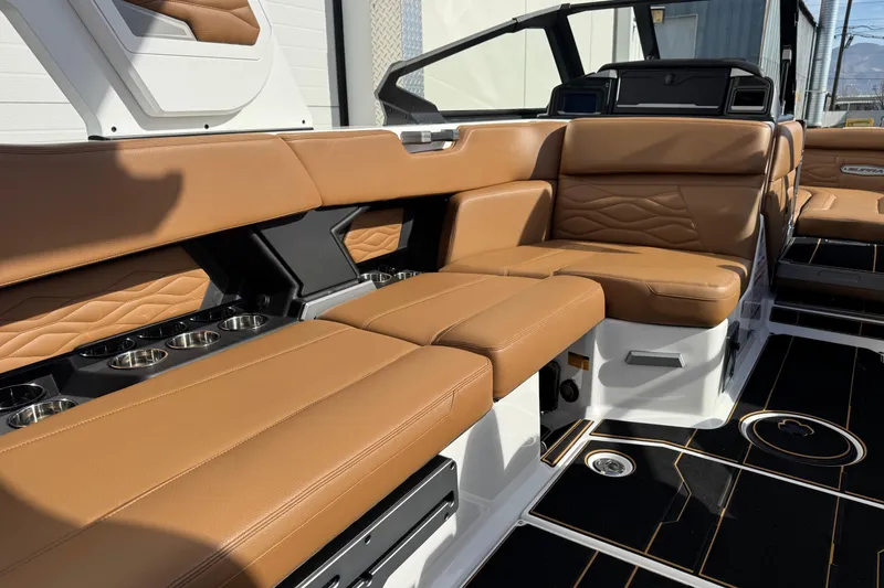 Slide: The Image of Luxurious interior of 2026 Supra SL 575 boat with tan leather seating and cup holders. - 10