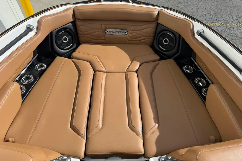 Slide: The Image of 2026 Supra SL 575 boat interior with tan leather seating and integrated speakers. - 6
