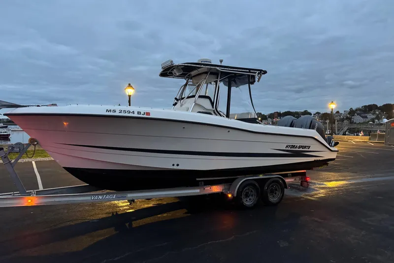 The Image of 2001 Hydra-Sports Vector 2390 CC boat on trailer at dusk, parked in marina. - 1
