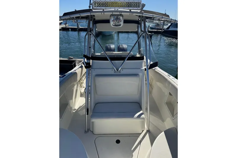 Slide: The Image of 2001 Hydra-Sports Vector 2390 CC boat interior with seating and T-top, docked at marina. - 3