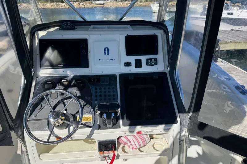 Slide: The Image of 2001 Hydra-Sports Vector 2390 CC boat cockpit with steering wheel and navigation equipment. - 7