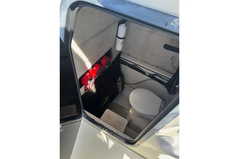 Slide: The Image of 2001 Hydra-Sports Vector 2390 CC boat interior with toilet and safety equipment. - 8