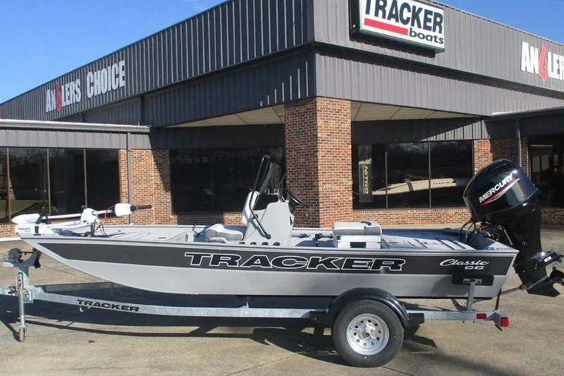 The Image of 2026 Tracker Bass Tracker Classic CC boat on trailer outside dealership. - 1