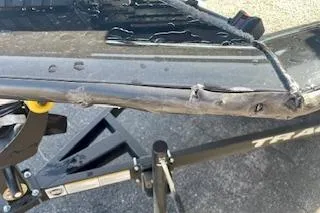 Slide: The Image of Damaged hull of 2025 Tracker Pro Team 175 TXW boat on trailer. - 10
