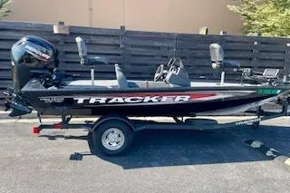 Slide: The Image of 2025 Tracker Pro Team 175 TXW boat on trailer, parked outdoors. - 13