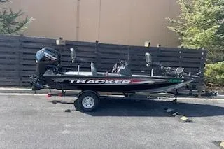 Slide: The Image of 2025 Tracker Pro Team 175 TXW boat on trailer, parked outdoors. - 8