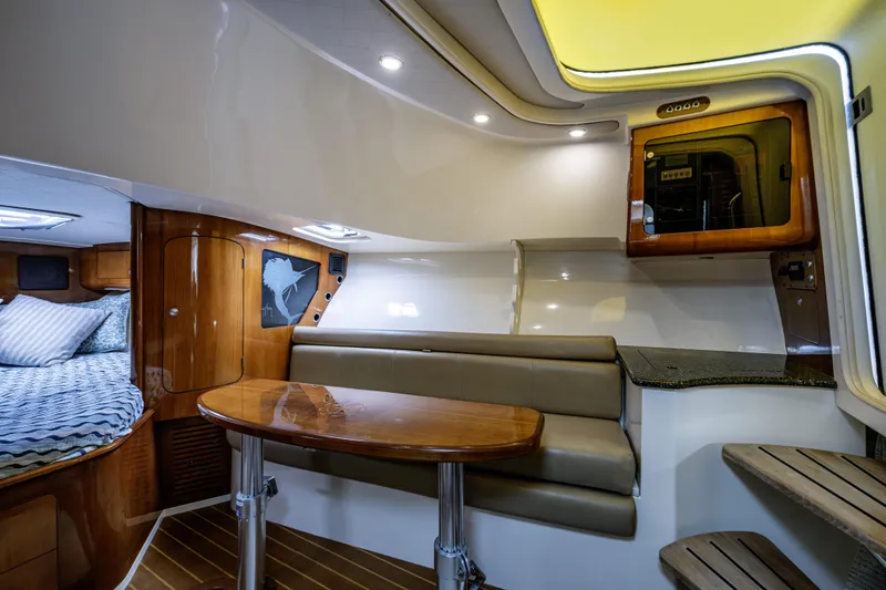 Slide: The Image of Luxurious interior of 2010 Scout 350 Abaco boat with wood finishes and cozy seating area. - 16