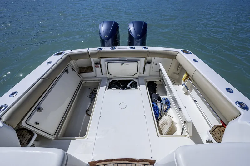 Slide: The Image of 2010 Scout 350 Abaco boat interior with open storage compartments and twin engines. - 21