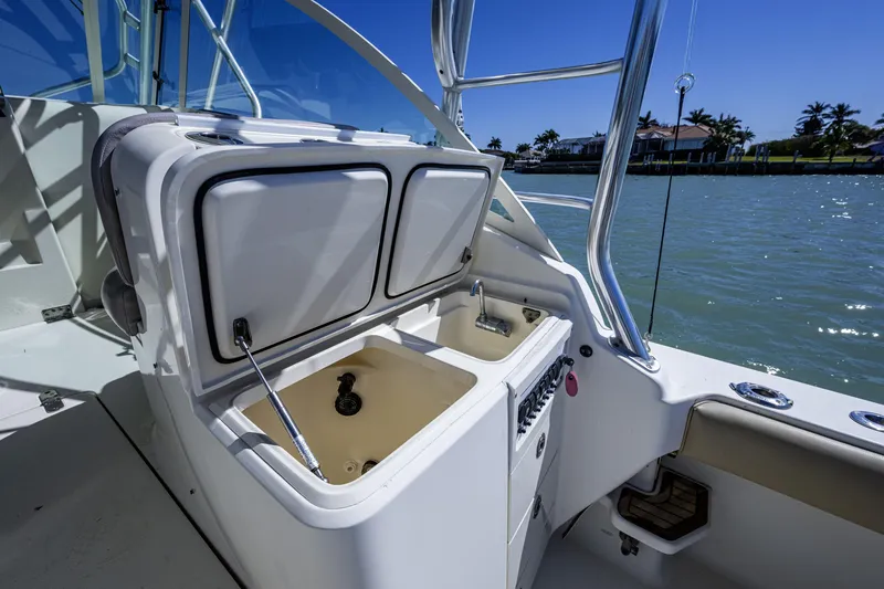 Slide: The Image of 2010 Scout 350 Abaco boat interior with open storage compartments and sink. - 23