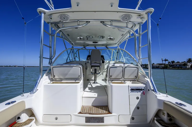 Slide: The Image of 2010 Scout 350 Abaco boat interior with helm, seating, and storage compartments. - 24