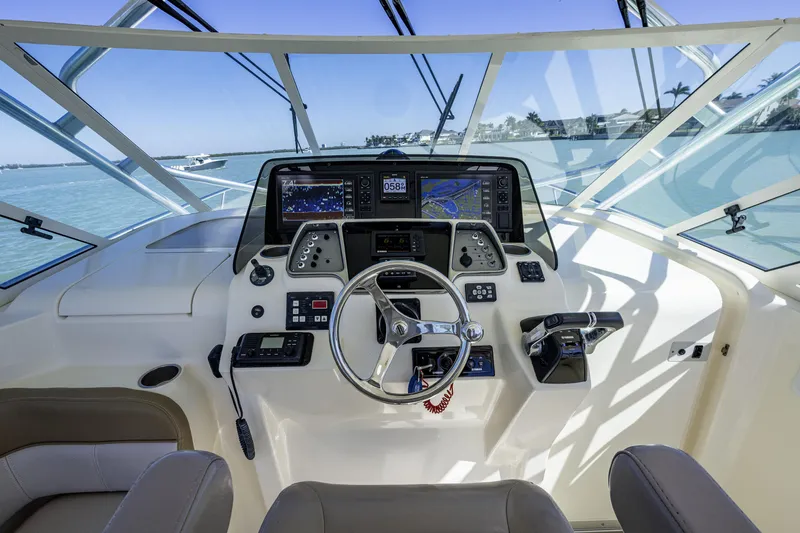 Slide: The Image of 2010 Scout 350 Abaco boat cockpit with advanced navigation controls and steering wheel. - 28