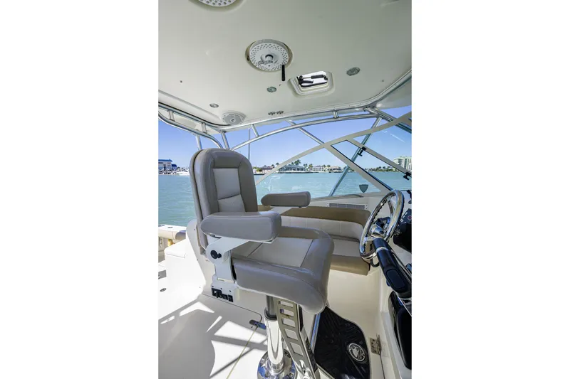 Slide: The Image of Captain's chair and helm of 2010 Scout 350 Abaco boat, overlooking marina. - 30