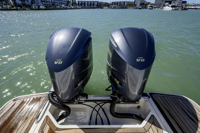 Slide: The Image of Twin Yamaha V8 engines on a 2010 Scout 350 Abaco boat, docked in a marina. - 32