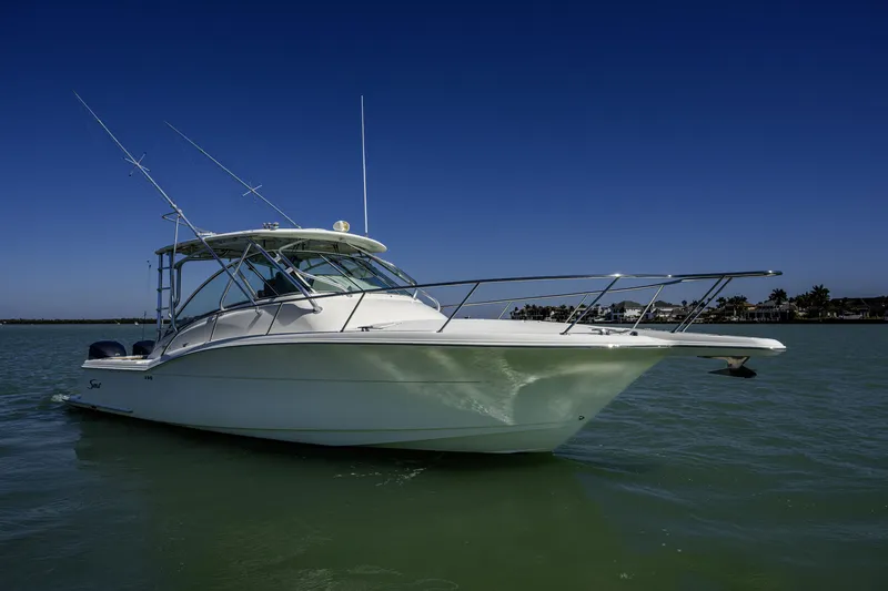 Slide: The Image of 2010 Scout 350 Abaco boat on calm water under clear blue sky. - 34