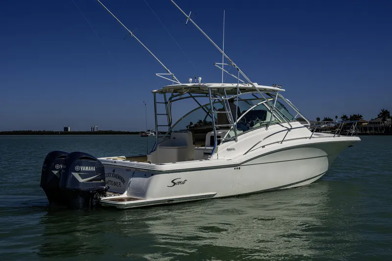 Slide: The Image of 2010 Scout 350 Abaco boat with dual Yamaha engines on calm water. - 35