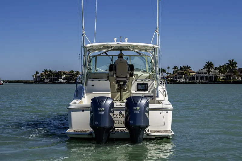 Slide: The Image of 2010 Scout 350 Abaco boat with dual V8 engines on calm water. - 36