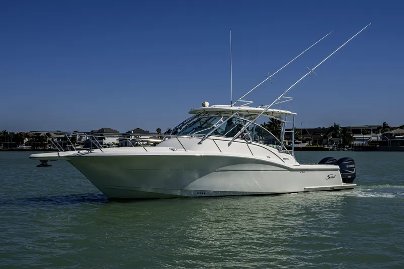 Slide: The Image of 2010 Scout 350 Abaco boat cruising on calm water under clear blue sky. - 37