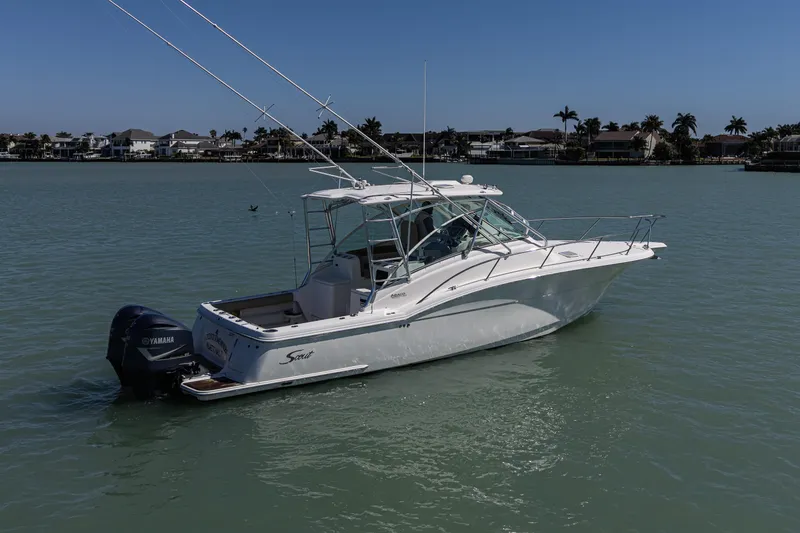 Slide: The Image of 2010 Scout 350 Abaco boat on calm water with Yamaha engine, coastal background. - 6