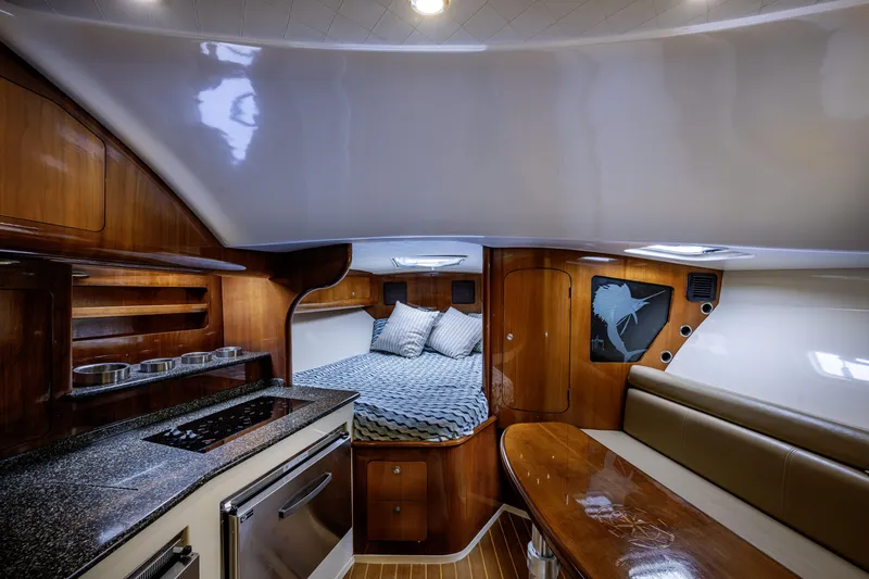 Slide: The Image of Luxurious interior of 2010 Scout 350 Abaco boat with wood finish and cozy bed. - 9