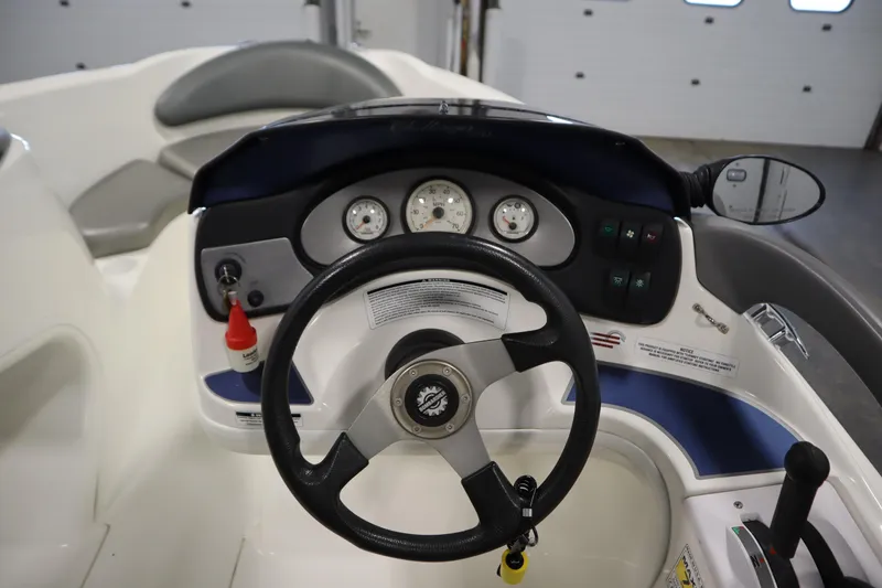 Slide: The Image of 2001 Sea-Doo Challenger 1800 boat dashboard with steering wheel and gauges. - 14