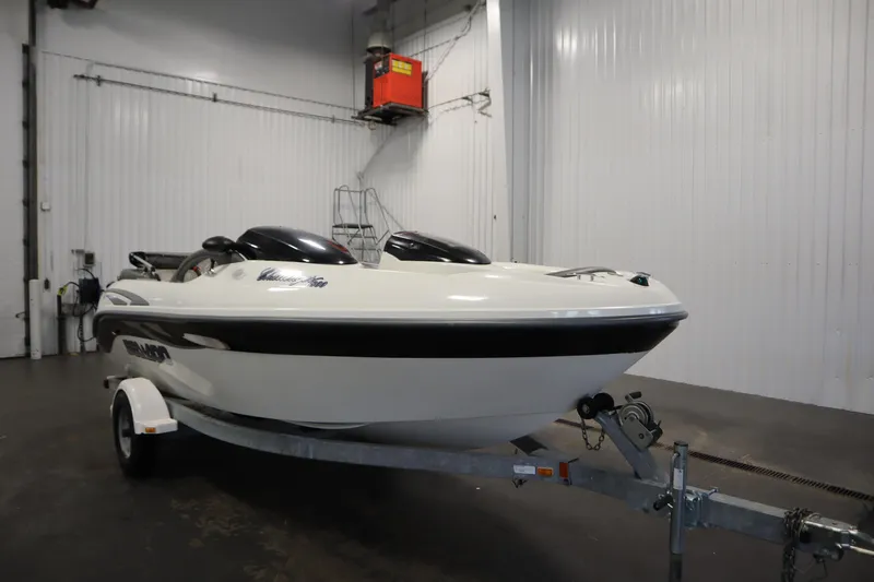 Slide: The Image of 2001 Sea-Doo Challenger 1800 boat on trailer in indoor storage facility. - 2
