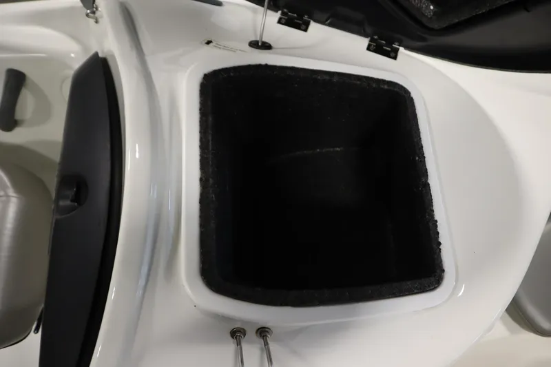 Slide: The Image of 2001 Sea-Doo Challenger 1800 storage compartment, open lid, white and black interior. - 23