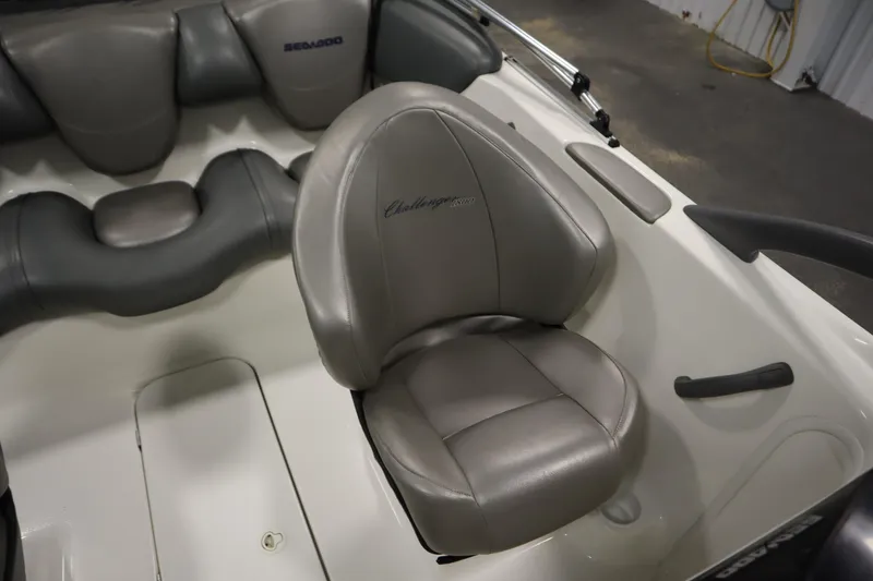 Slide: The Image of 2001 Sea-Doo Challenger 1800 boat interior with gray seating and steering area. - 25
