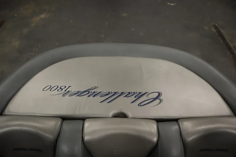 Slide: The Image of 2001 Sea-Doo Challenger 1800 boat seat with embroidered logo, gray upholstery. - 28