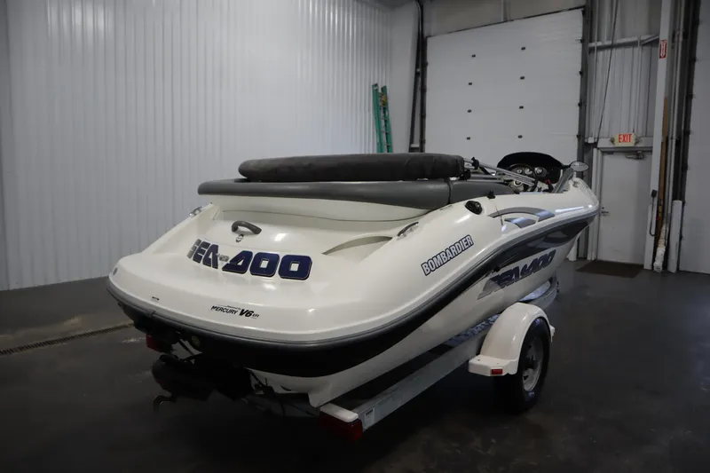 Slide: The Image of 2001 Sea-Doo Challenger 1800 boat in a garage, rear view, on a trailer. - 4