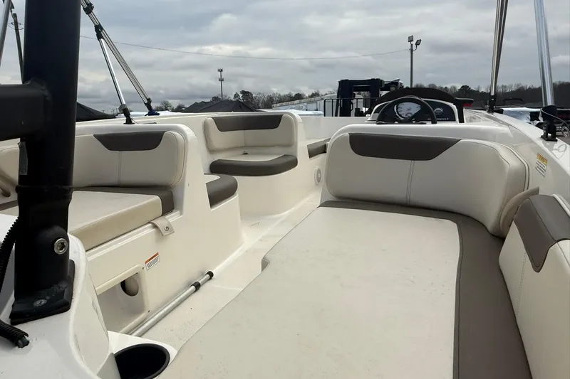 Slide: The Image of 2021 Bayliner Element E18 boat interior with cushioned seating and steering console. - 5