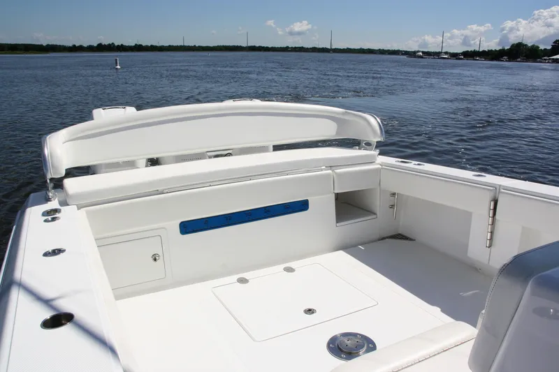 Slide: The Image of 2019 Bahama 41 boat deck with seating, on calm waters under a clear sky. - 13