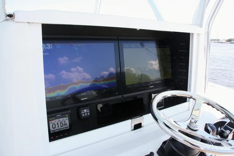 Slide: The Image of 2019 Bahama 41 boat helm with Garmin navigation screens and steering wheel. - 22