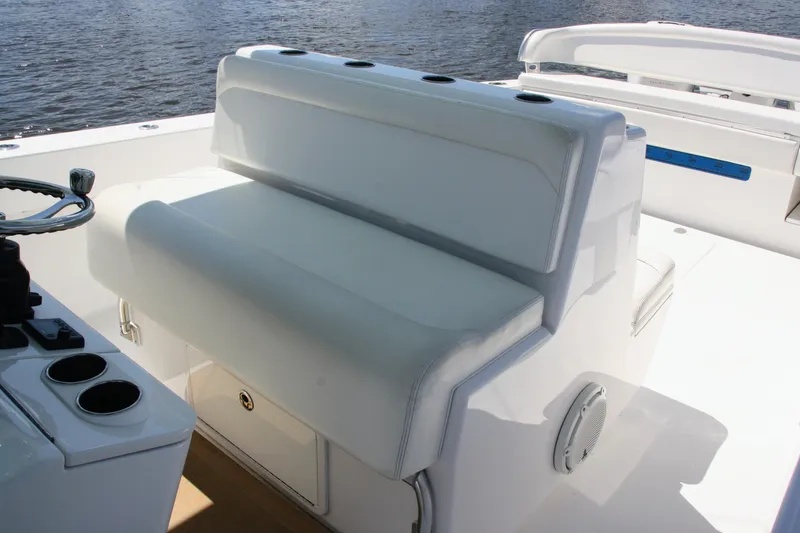 Slide: The Image of 2019 Bahama 41 boat interior with white seating and steering wheel. - 24