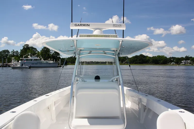 Slide: The Image of 2019 Bahama 41 boat with Garmin equipment on a calm lake under a clear sky. - 25
