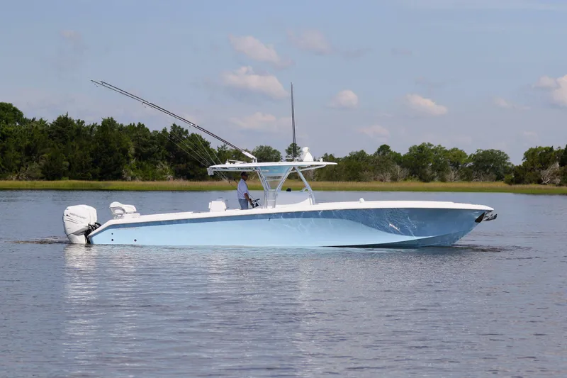 Slide: The Image of 2019 Bahama 41 boat cruising on calm water with scenic background. - 9