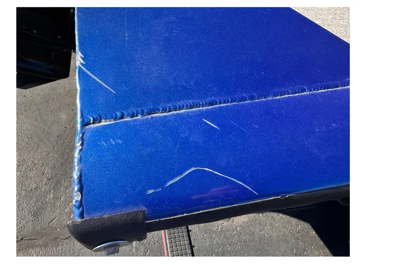 Slide: The Image of 2011 Tracker Pro Team 175 TF boat with visible scratches on blue surface. - 22