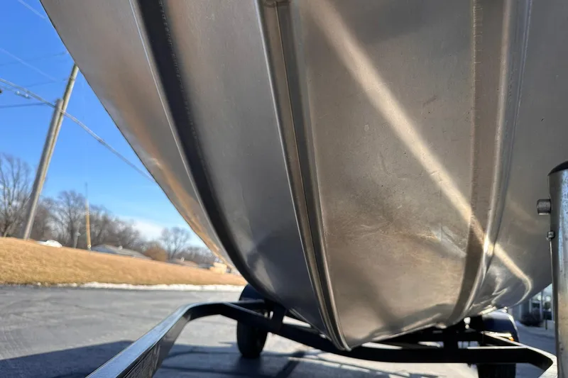 Slide: The Image of 2011 Tracker Pro Team 175 TF boat hull on trailer, sunny day background. - 26